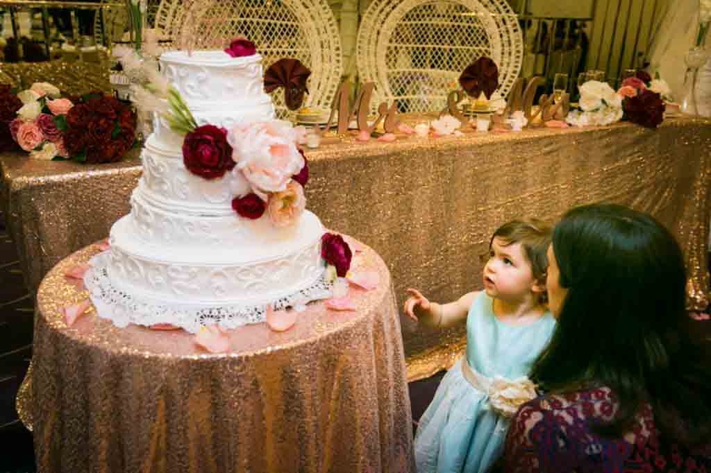 Little girl pointing to wedding cake at a Glen Terrace wedding