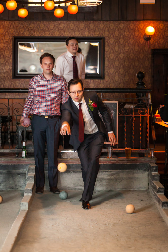 Groom playing bocce at Union Hall in Brooklyn