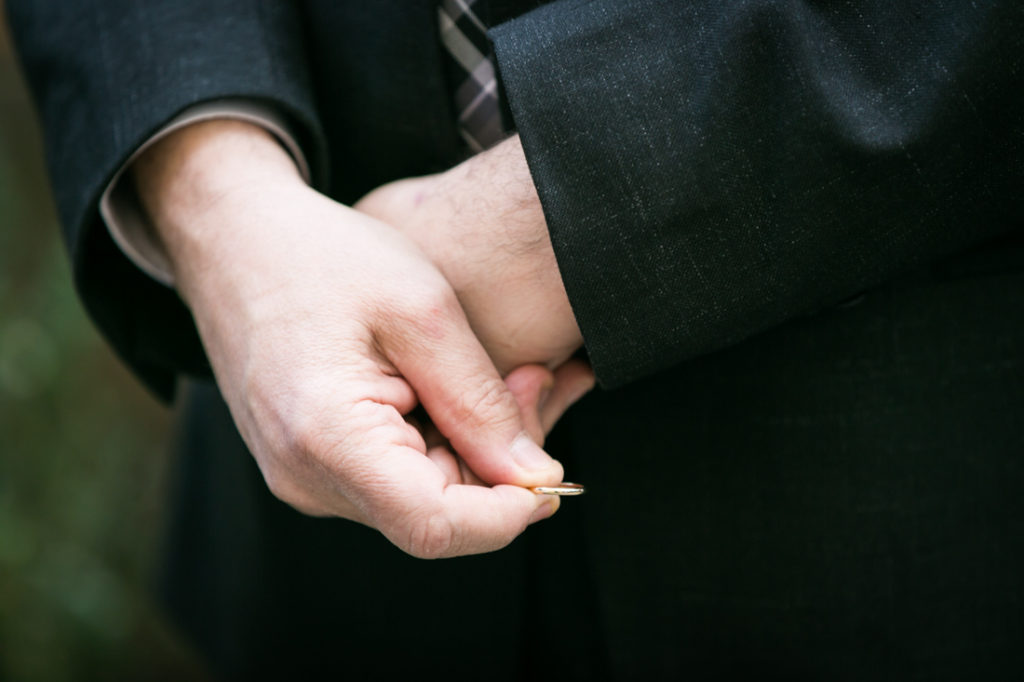 Hands holding a wedding ring for an article on the top fears about wedding photographers