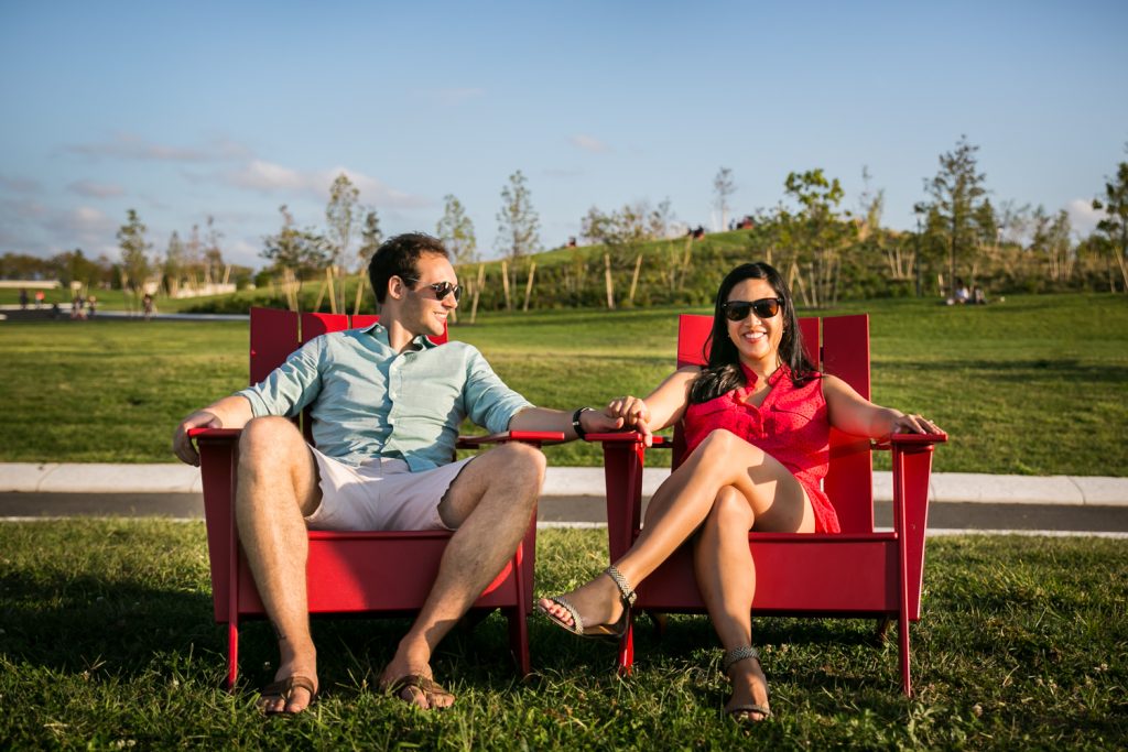 Couple sitting in adirondack chairs on Governors Island for a NYC wedding destination guide