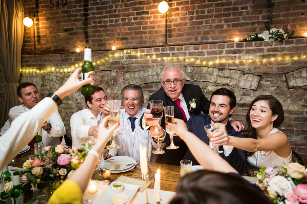 Guests toasting champagne glasses at a table