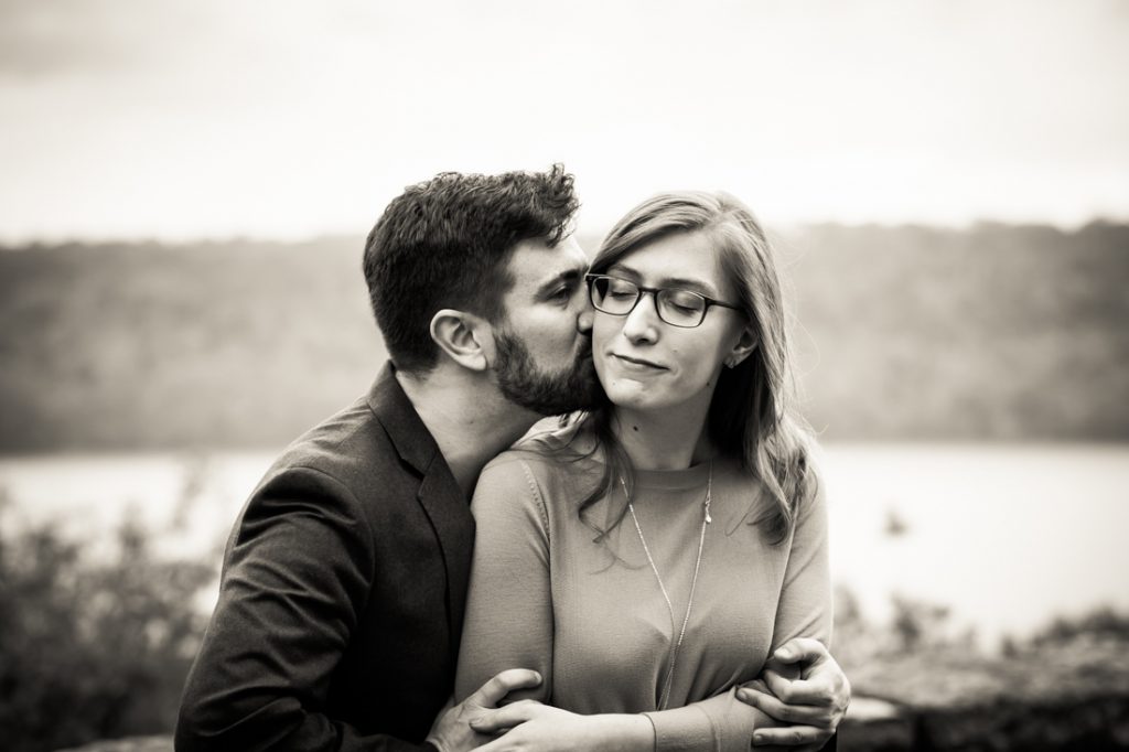 Kissing couple at a Fort Tryon Park engagement portrait