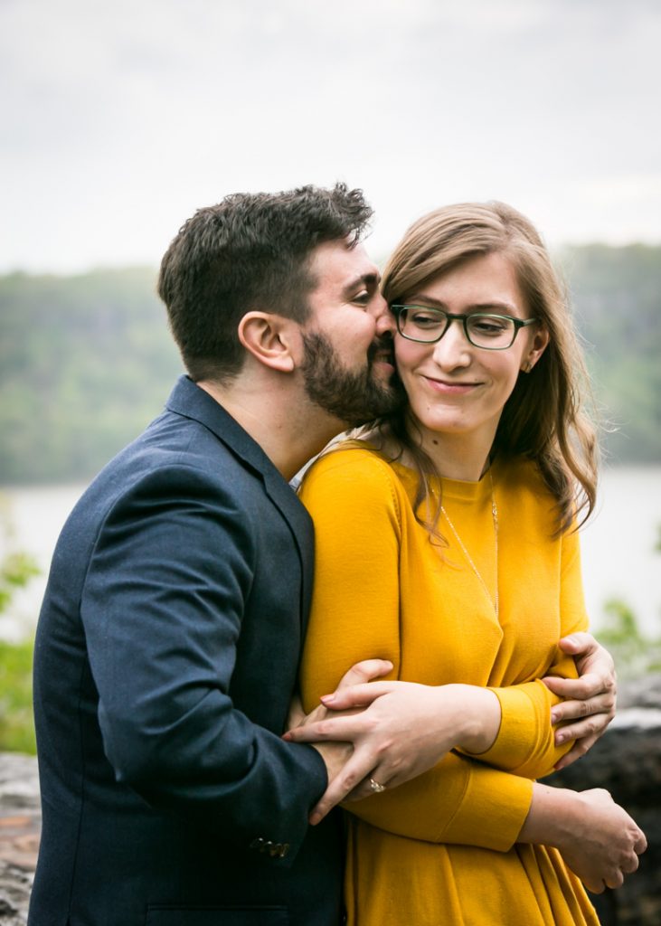 Kissing couple at a Fort Tryon Park engagement portrait