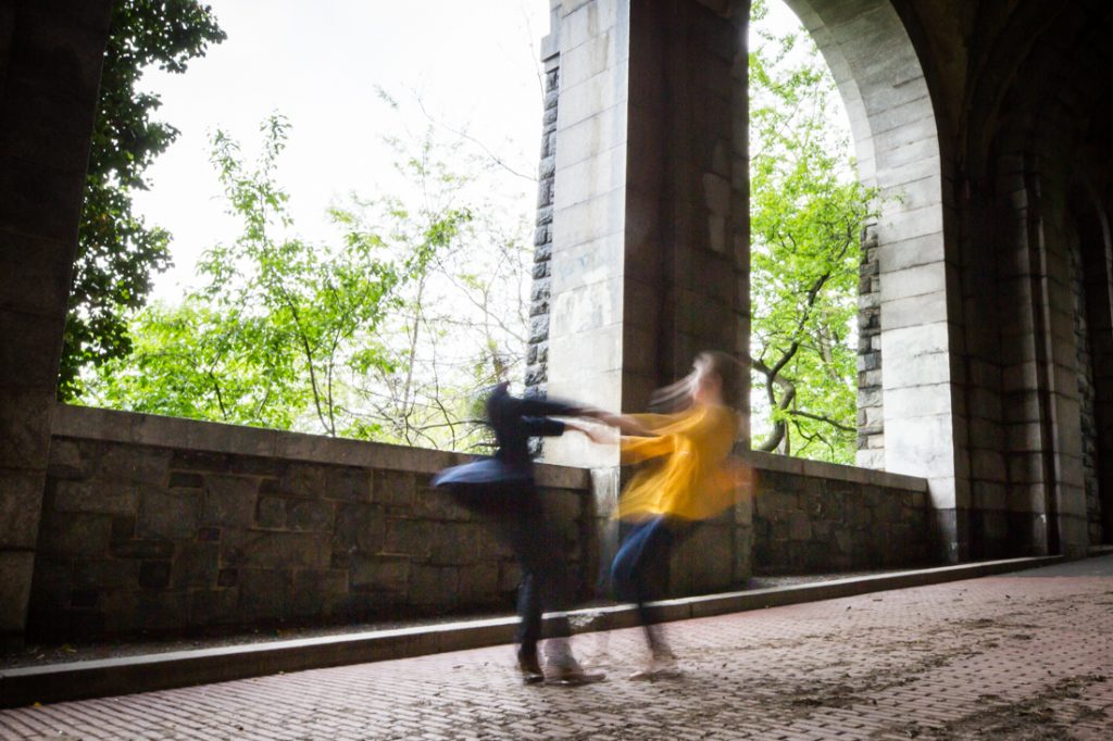 Twirling couple at a Fort Tryon Park engagement portrait