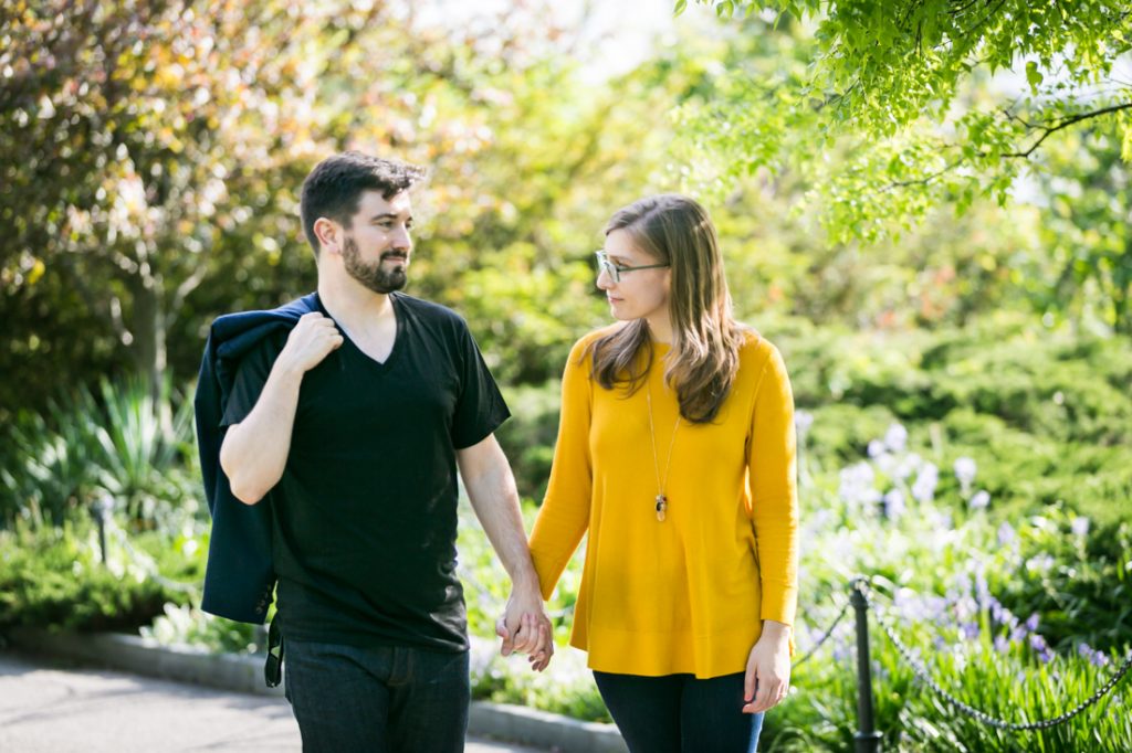 Couple walking hand-in-hand at a Fort Tryon Park engagement portrait