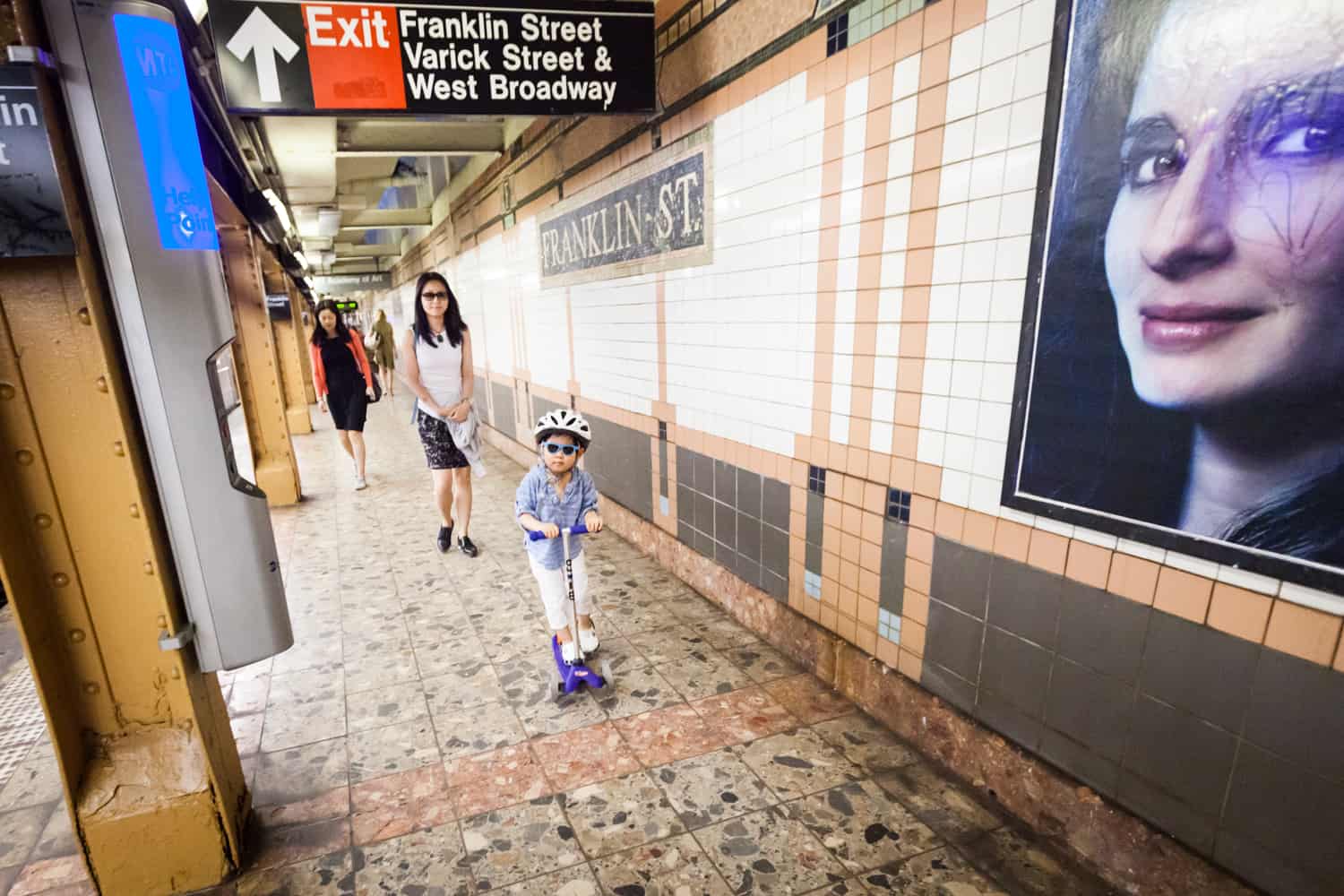 Mother and little boy walking on subway platform