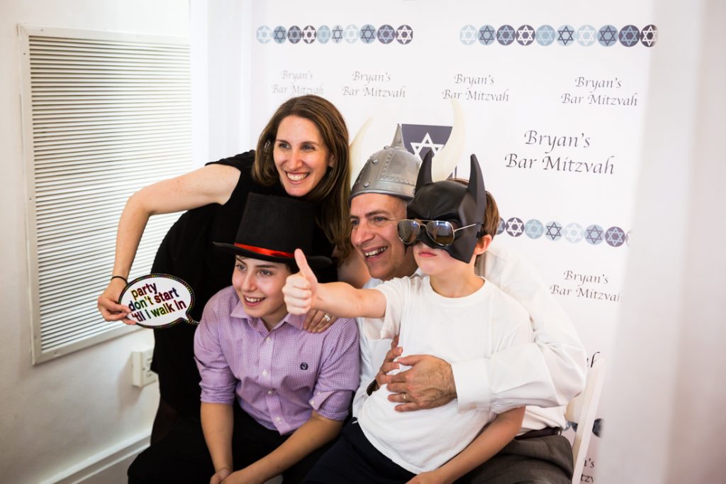 Guests in a photo booth by bar mitzvah photographer, Kelly Williams