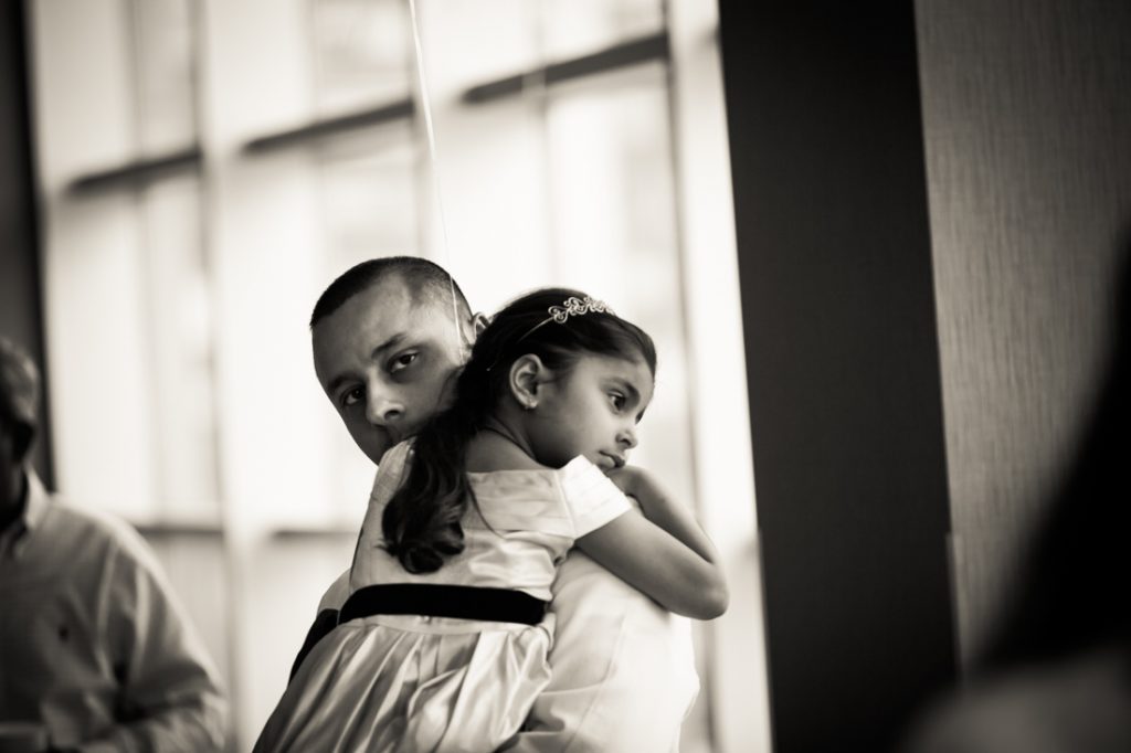 Father holding little girl during nontraditional baby shower