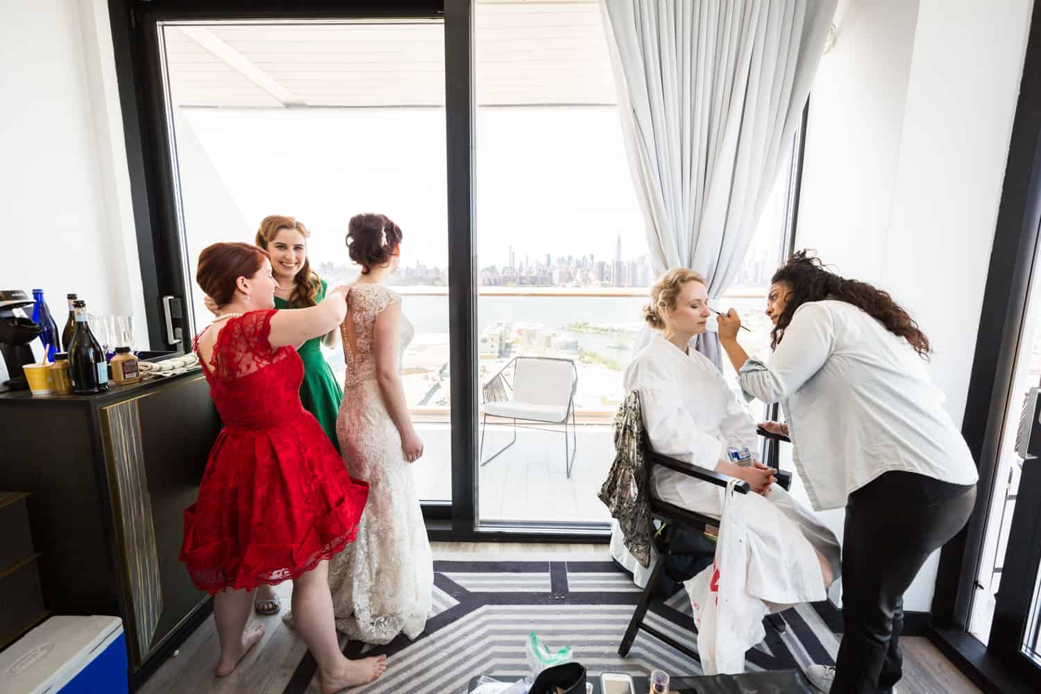 Bride and bridesmaids getting ready in William Vale hotel room with terrace