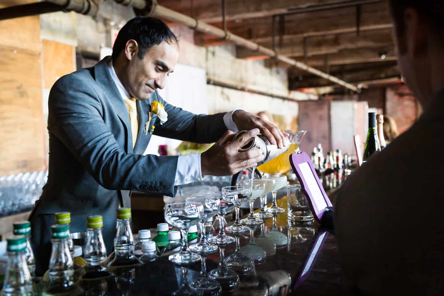 Groomsmen preparing cocktails at a Greenpoint Loft wedding