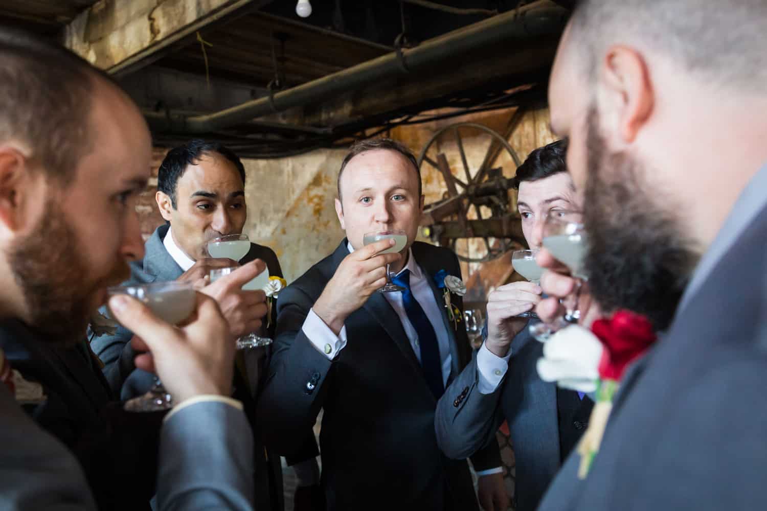 Groomsmen drinking cocktails at a Greenpoint Loft wedding