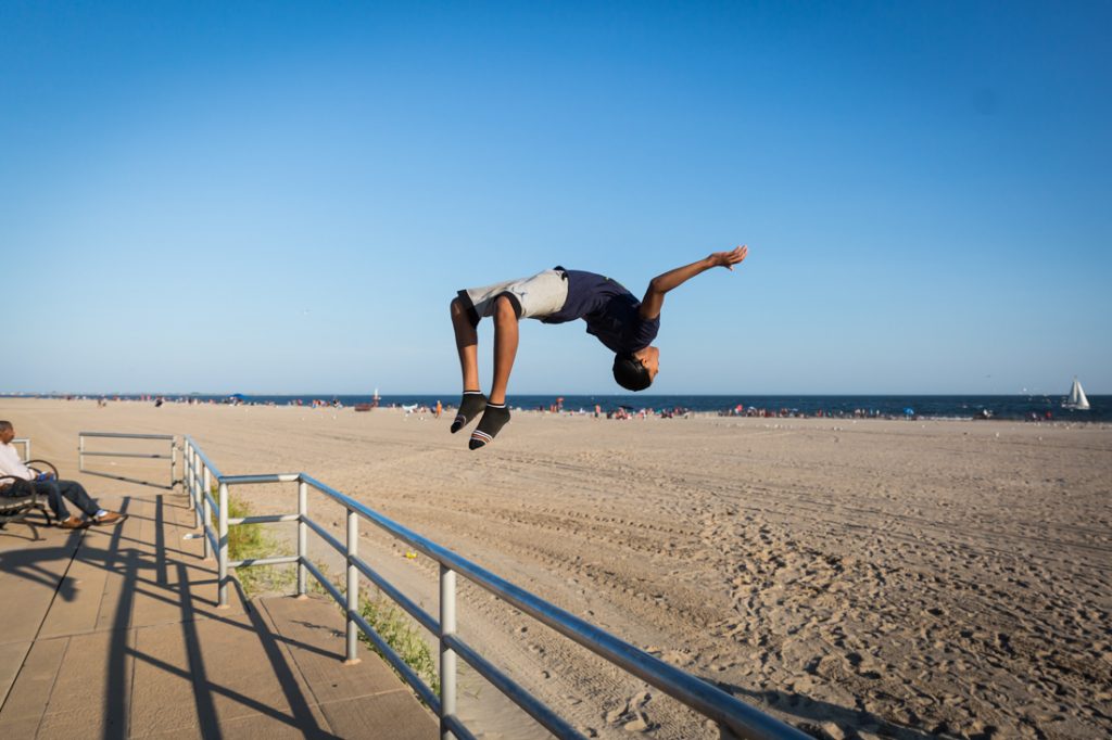 Kid doing a back flip at Coney Island