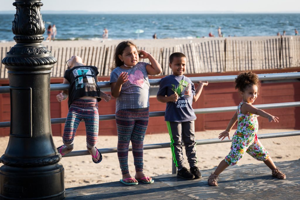 Kids posing for a photo on the Coney Island boardwalk