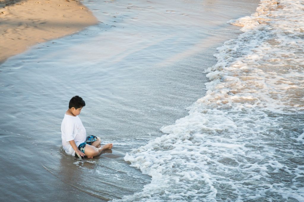 Kid in the surf at Coney Island