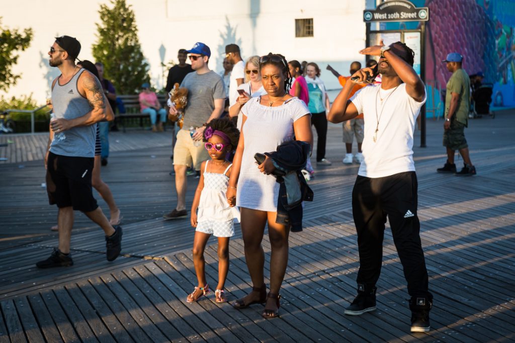 Mother and child wearing sunglasses on the Coney Island boardwalk