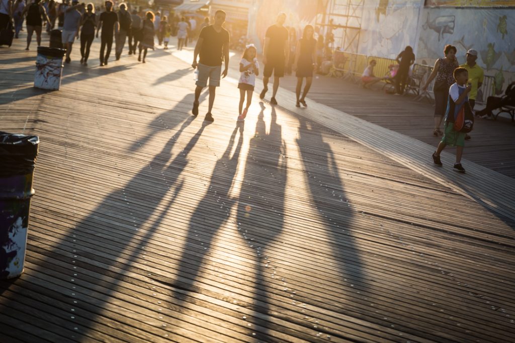 Shadows of tourists on the Coney Island boardwalk