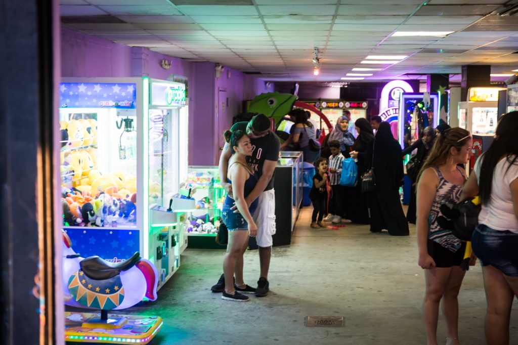 Lovers embracing at a Coney Island arcade