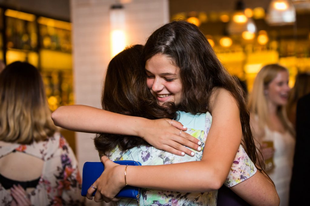 Guests at a rehearsal dinner for an article on details your wedding photographer needs to know