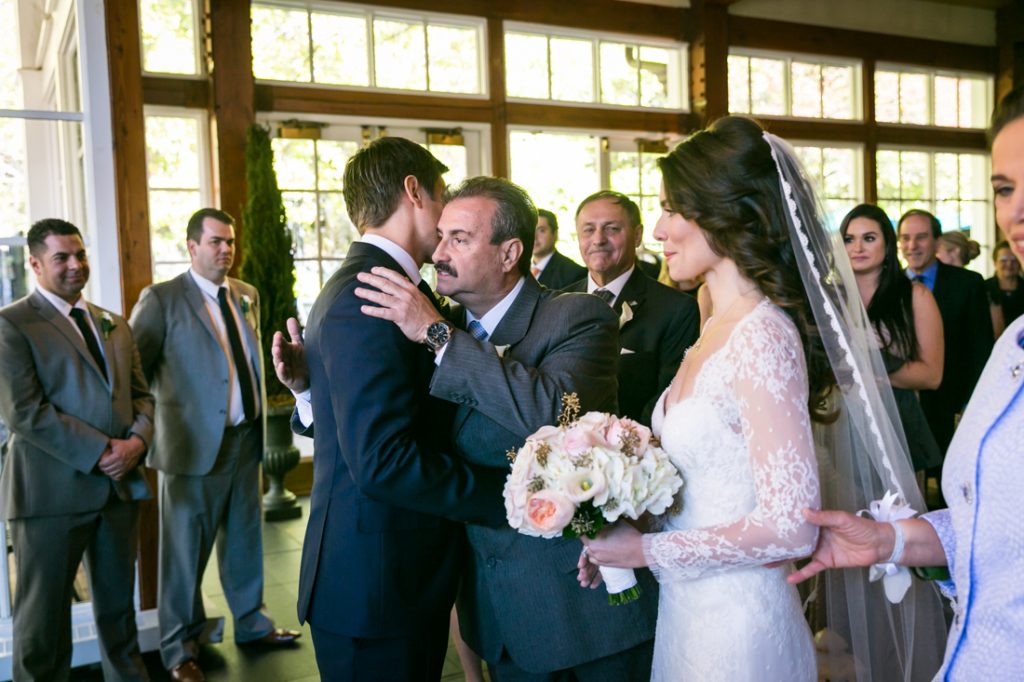 Father of bride greeting groom for an article on wedding officiant tips