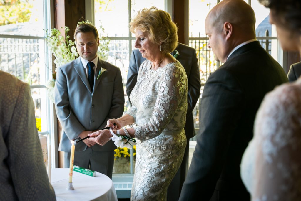 Mother of groom lighting a candle for an article on wedding officiant tips