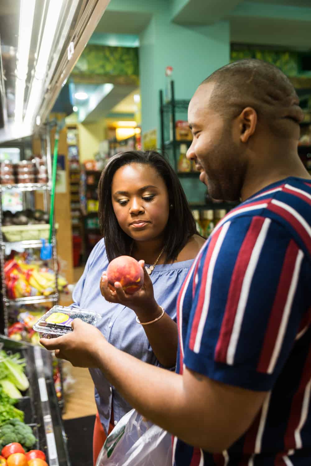 African American couple shopping for fruit together 