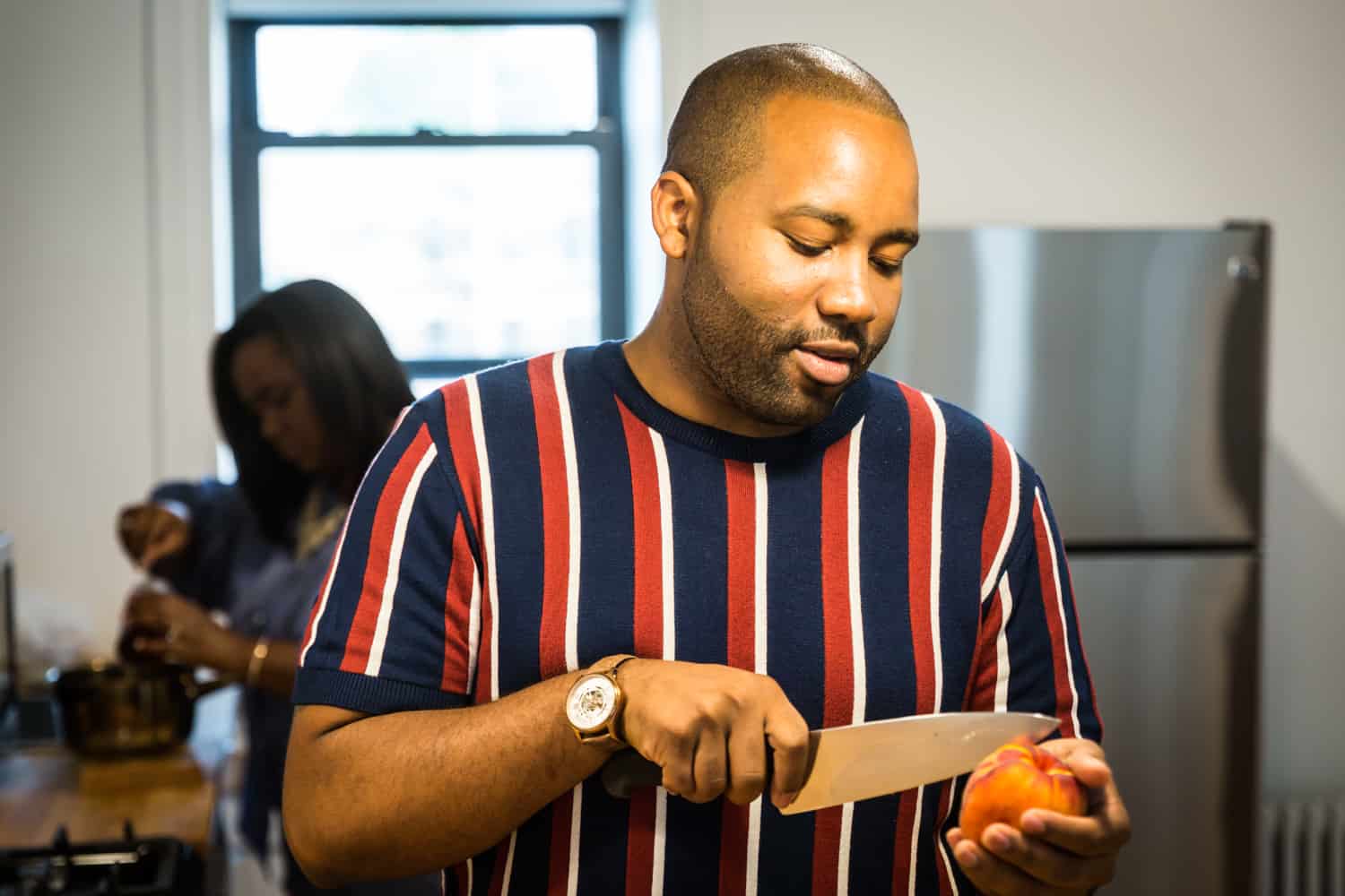 African American man cutting peach for an article on creative engagement photo shoot ideas