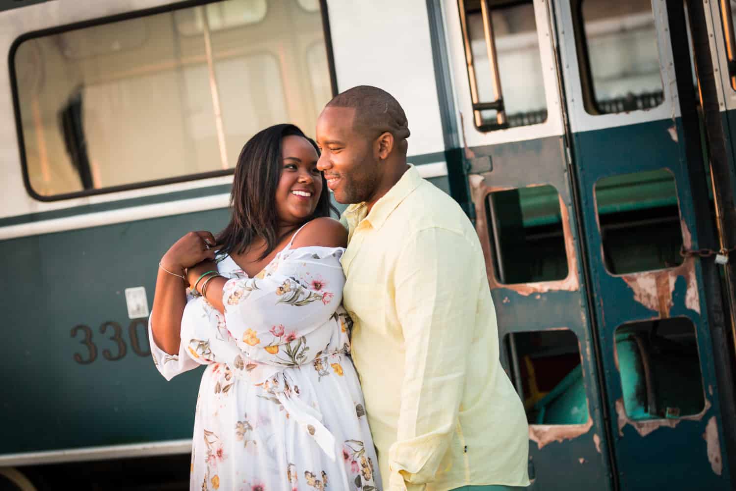 Couple in front of bus for an article on creative engagement photo shoot ideas