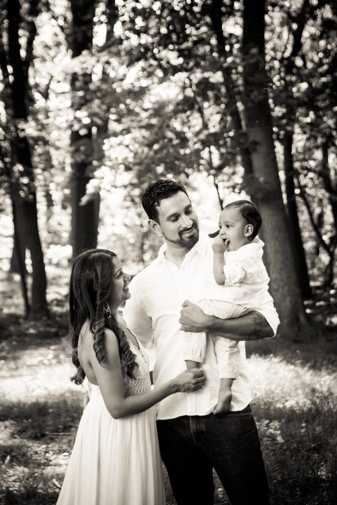 Black and white photo of parents holding son in Forest Park