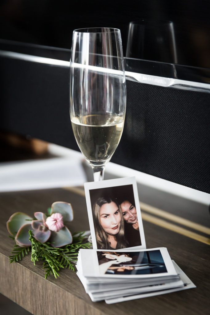 Glass of champagne and polaroids for a 26 Bridge wedding