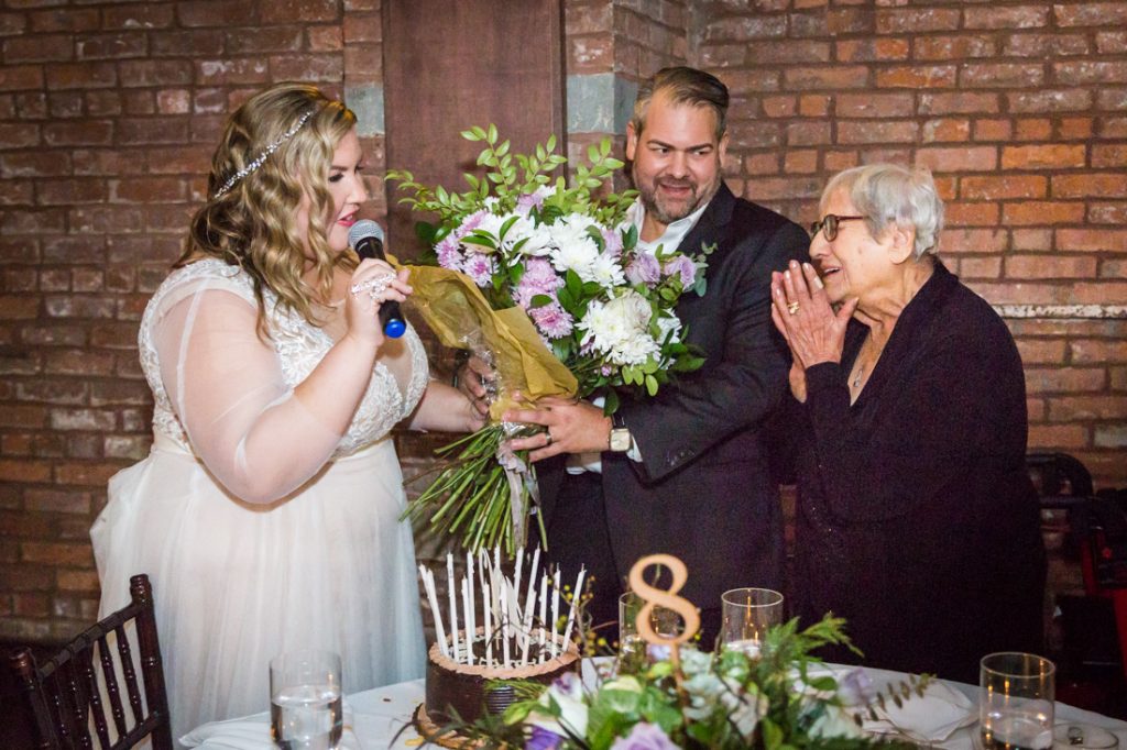 Giving flowers to grandmother at a 26 Bridge wedding