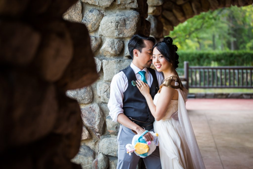 Bride and groom against stone pillar at a Bear Mountain Inn wedding