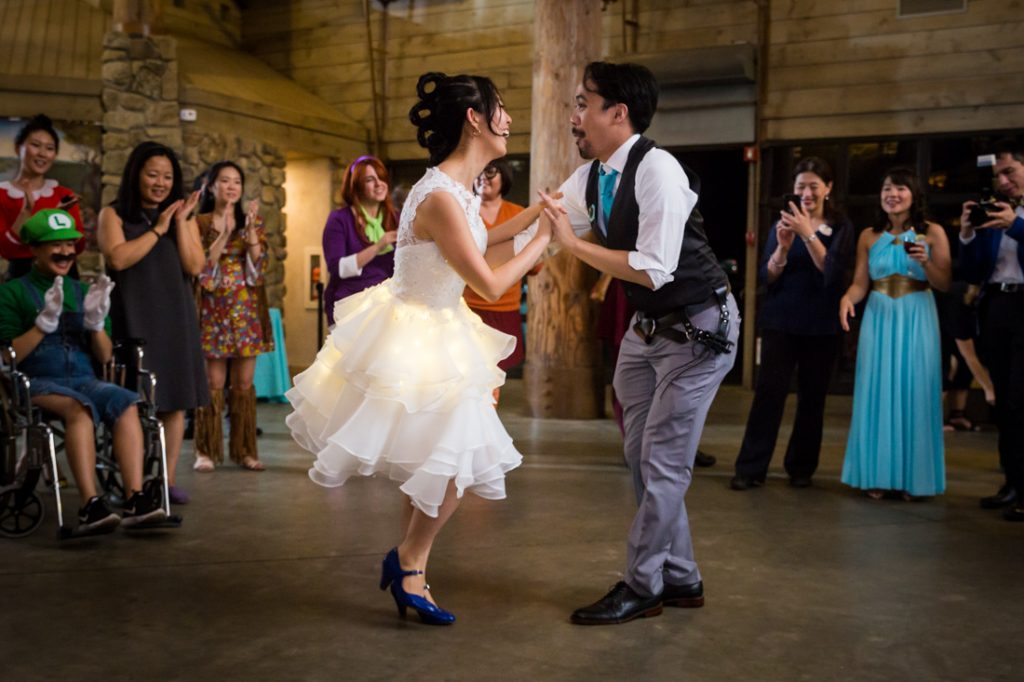 Bride and groom swing dancing at a Bear Mountain Carousel wedding