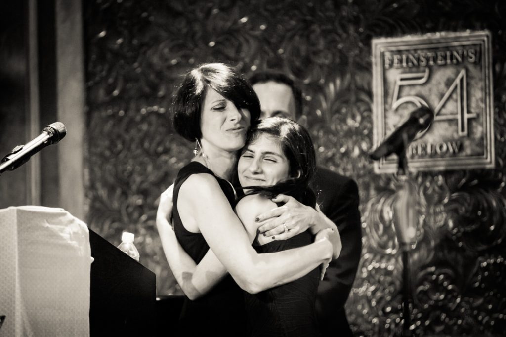 Mother hugging daughter at a bat mitzvah for an article on ‘How to Find a Venue’