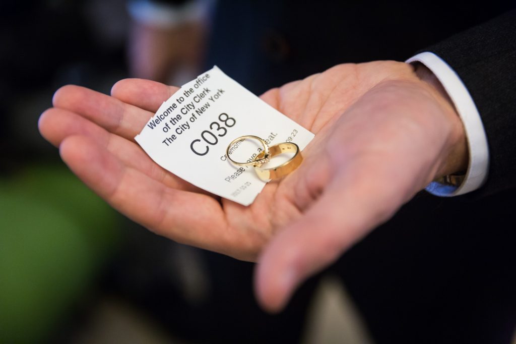 Ticket number and wedding rings for an article on How to Get Married at City Hall in Any NYC Borough