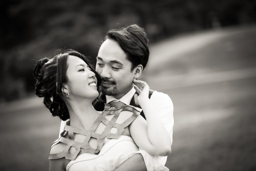 Black and white photo of bride touching groom's cheek at a Bear Mountain Inn wedding