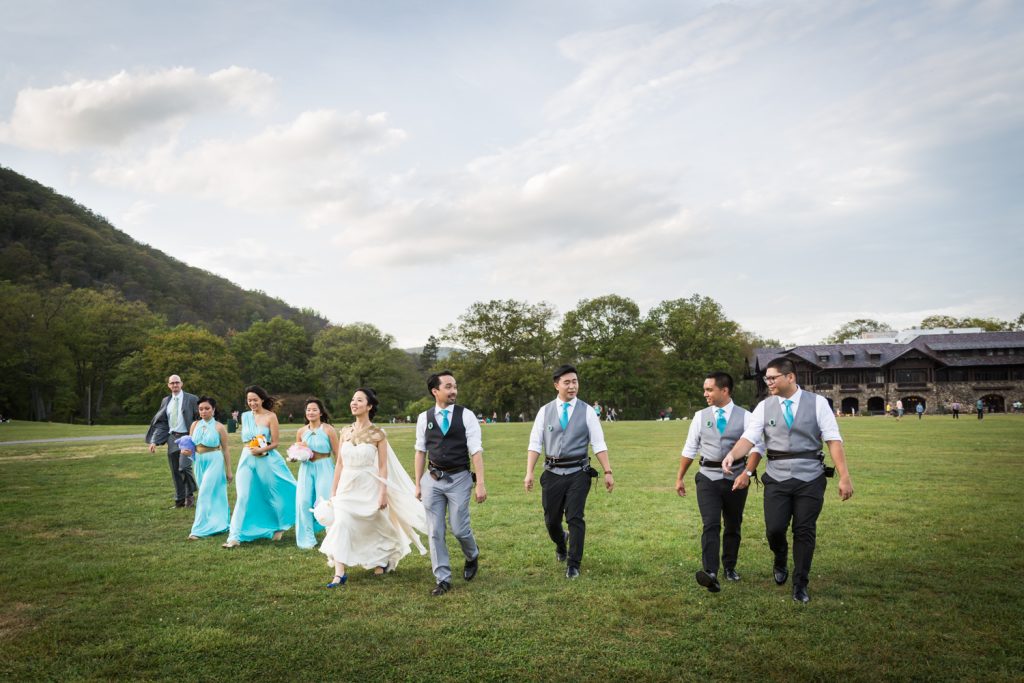 Bridal party walking across a field at a Bear Mountain Inn wedding