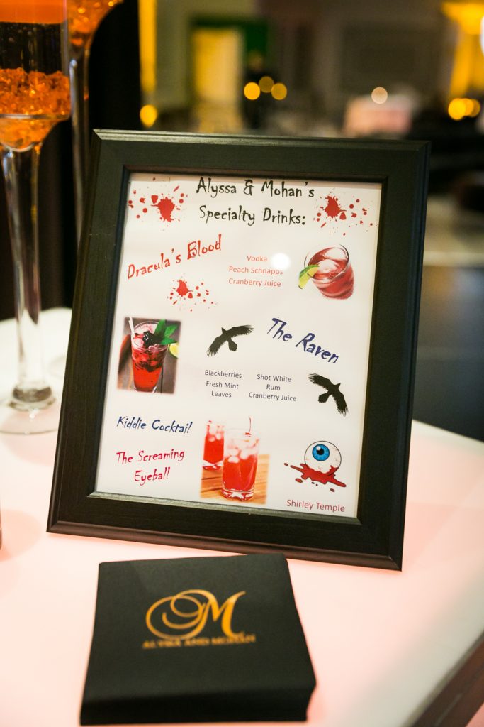 List of personalized cocktails at a Halloween-themed wedding reception