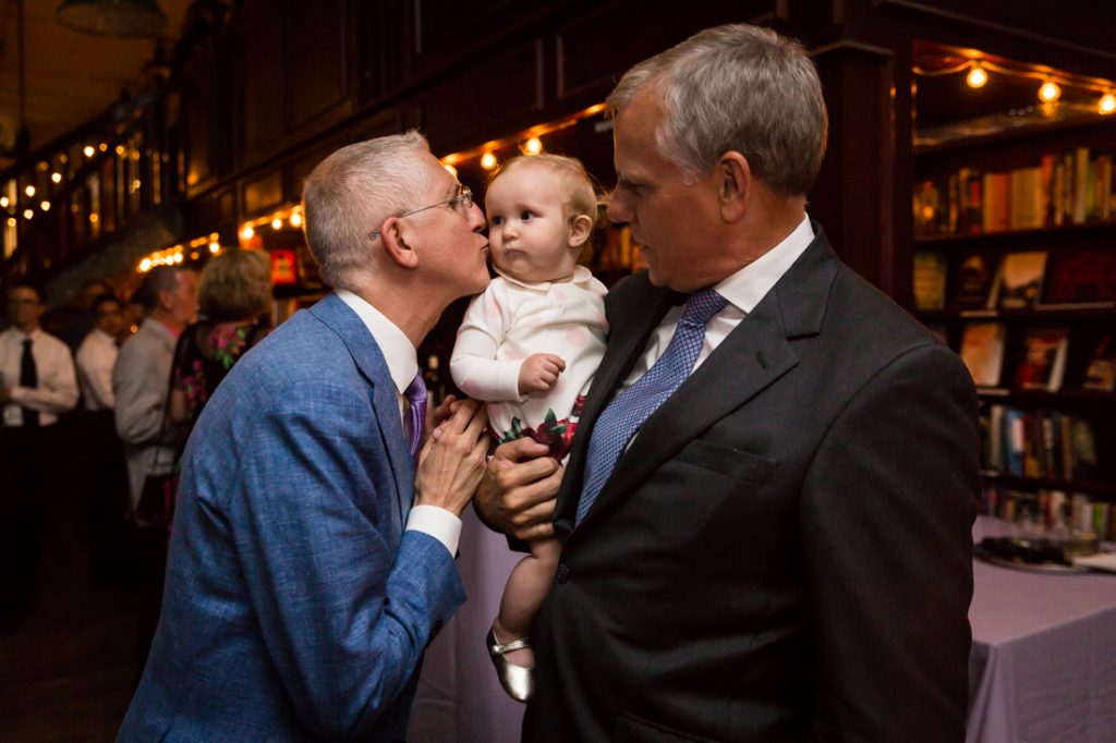 Groom, guest, and baby at a Housing Works Bookstore Cafe wedding