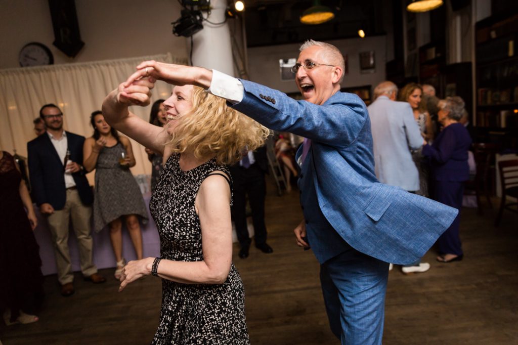 Groom and guest dancing at a Housing Works Bookstore Cafe wedding