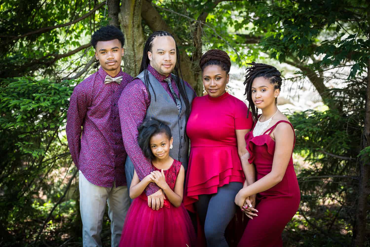 African American family of two parents and three kids in the woods