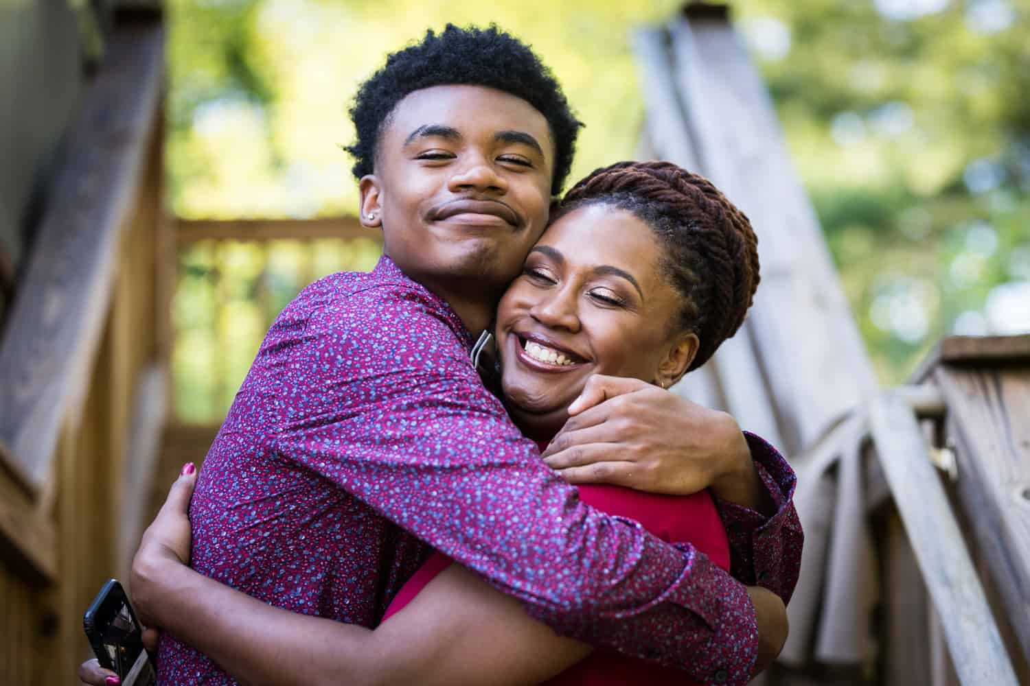African American mother and son hugging during a family reunion portrait