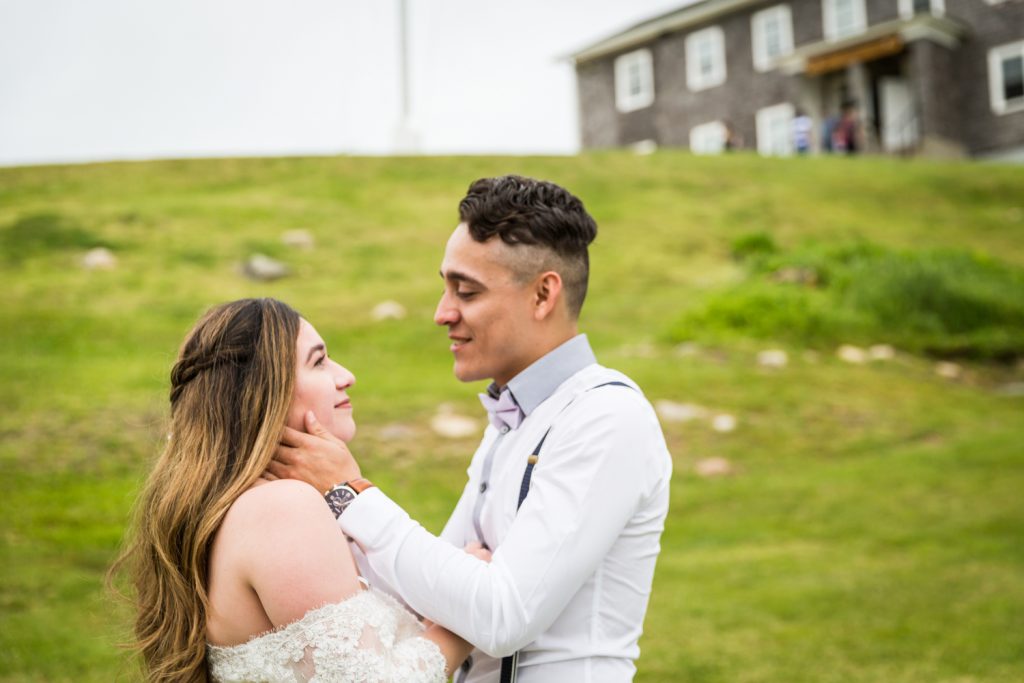 Groom holding bride's face after first look