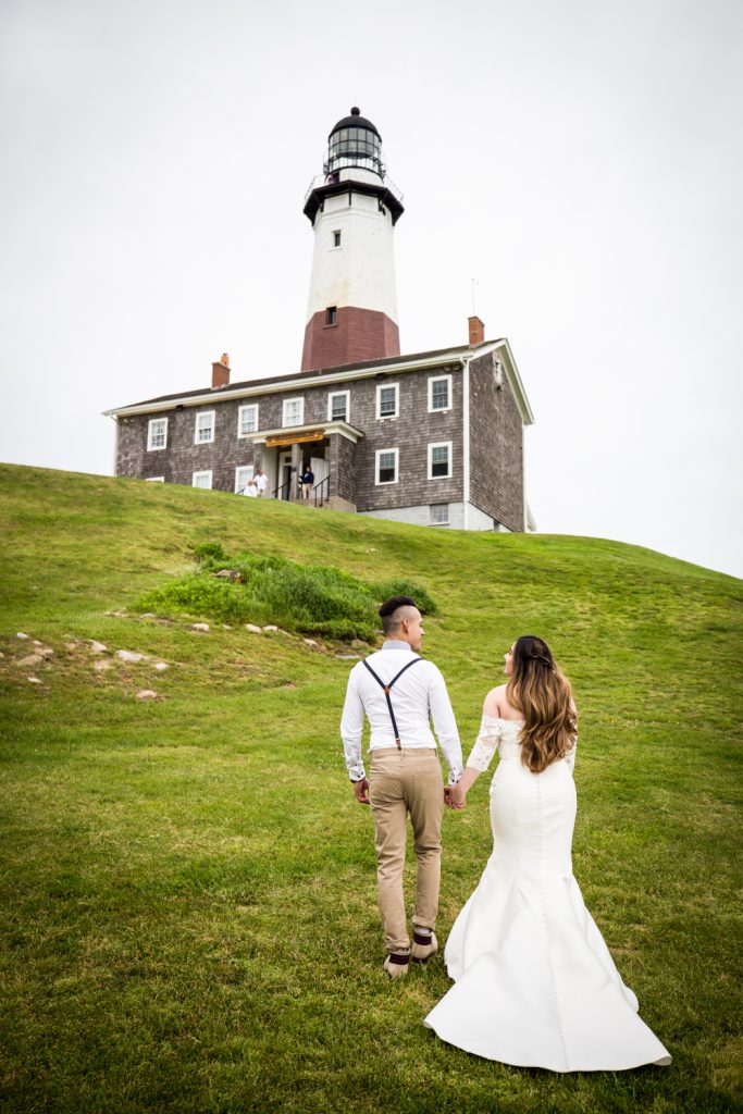 Bride and groom walking for an article on Montauk Lighthouse wedding tips