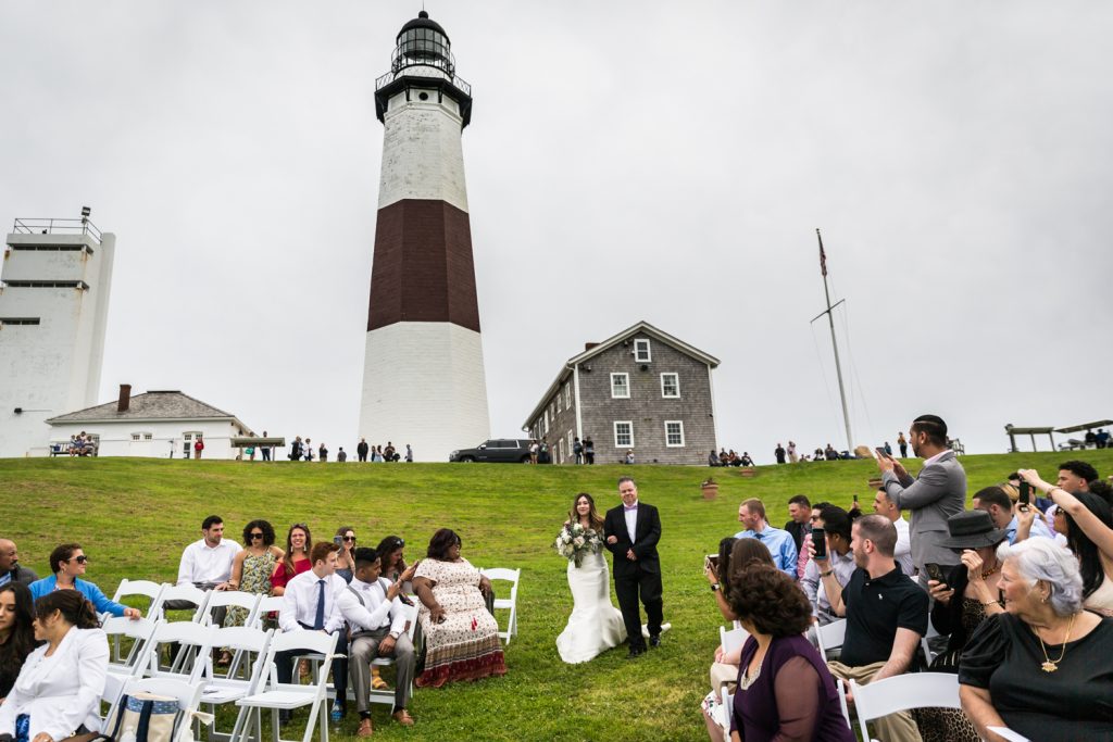 Bride walking down the aisle for an article on Montauk Lighthouse wedding tips