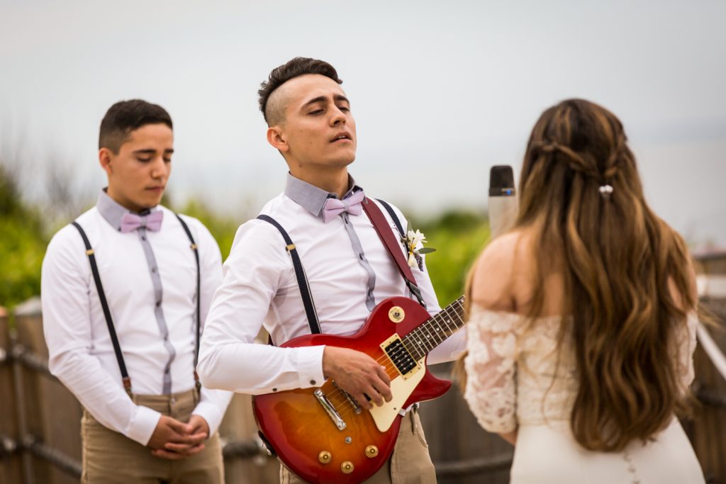 Groom playing guitar and bride singing 