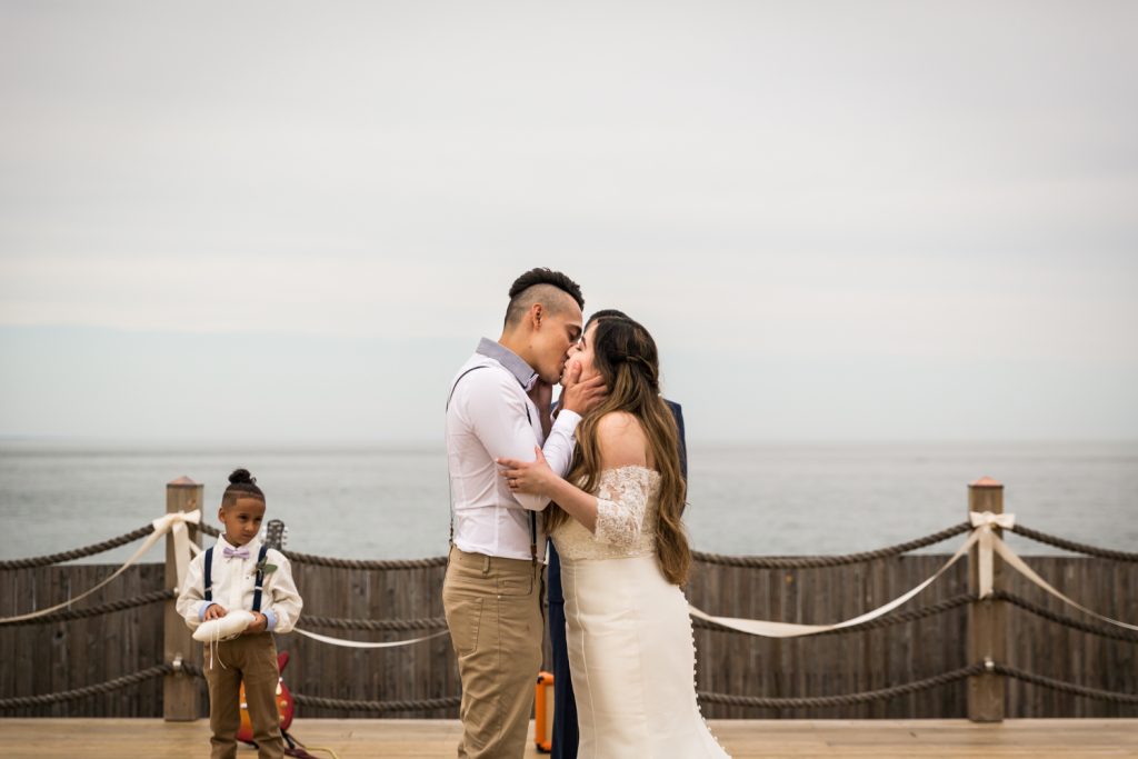 Bride and groom kissing for an article on Montauk Lighthouse wedding tips