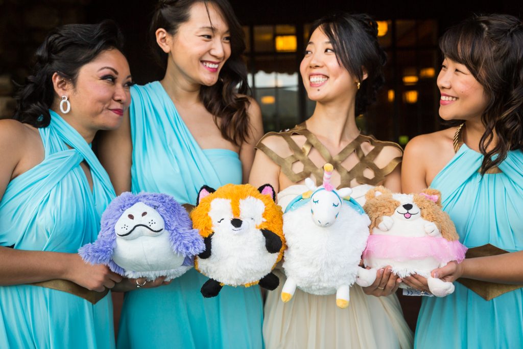 Bride and bridesmaids with stuffed animal bouquets for an article on bouquet and garter toss alternatives