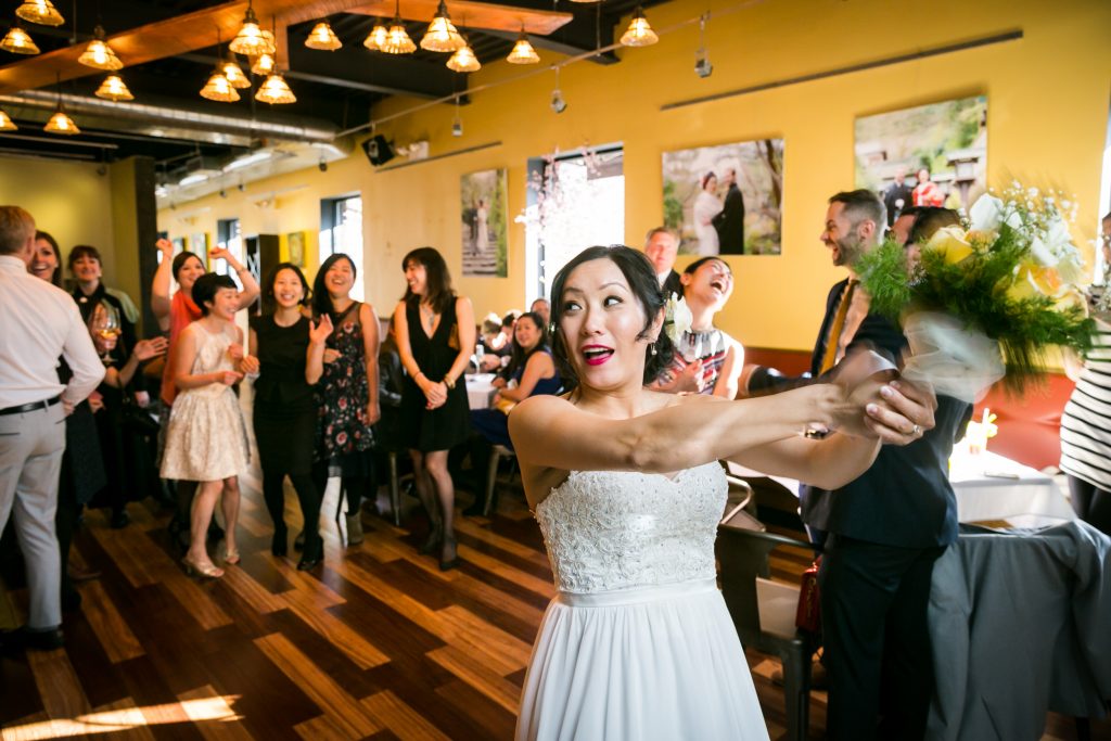 Bride tossing bouquet for an article on bouquet and garter toss alternatives