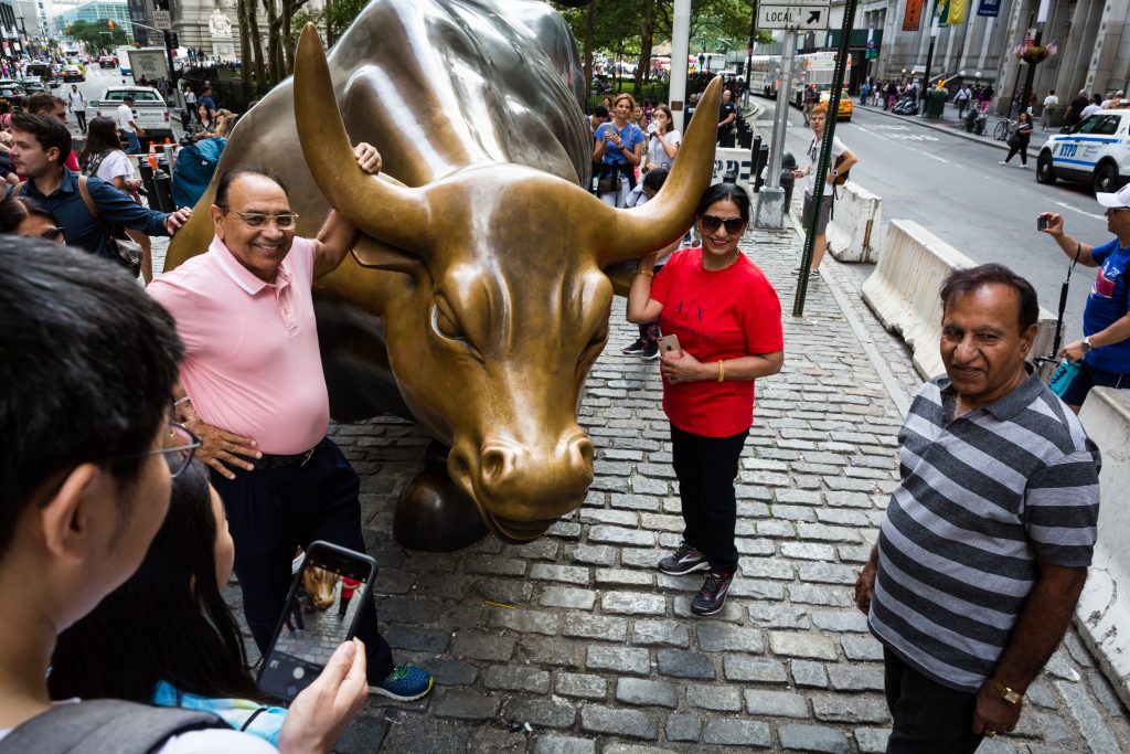 Wall Street bull and tourists for an article on City Hall wedding portrait locations