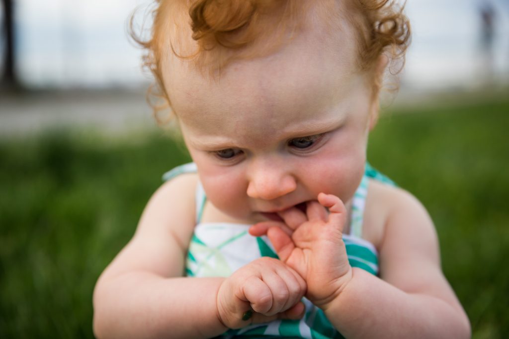 Baby chewing on fingers in a Hudson River Park Family Portrait